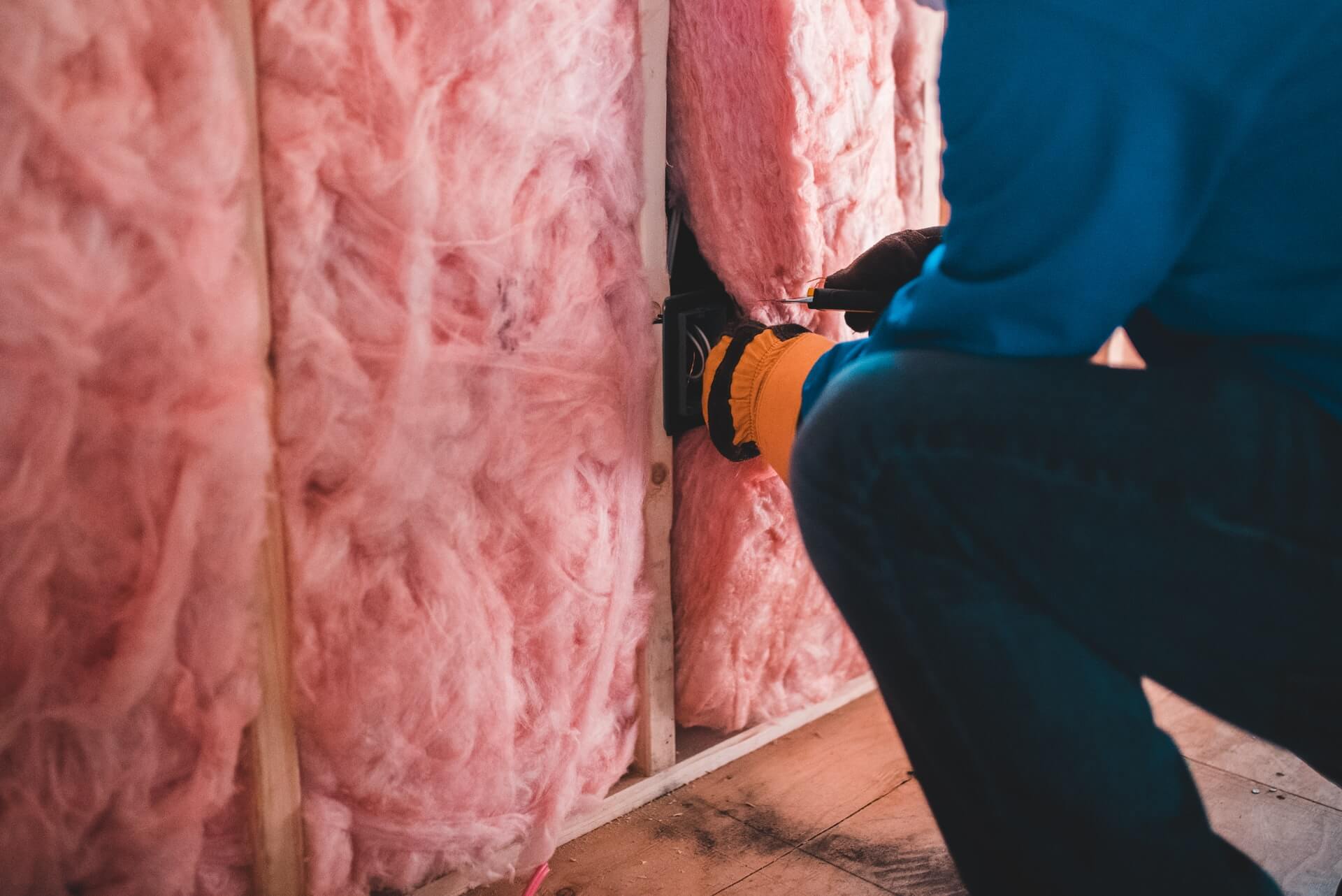 man upgrading insulation as part of sustainable remodeling